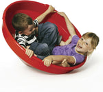 Two children spinning in the Gonge Giant Spinning Top together.