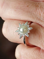 A hand wearing the Sun with Pearl Fidget Spinner in Solid Copper (Silver).