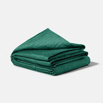 The forest green 15 lb Gravity Cooling Weighted Blanket neatly folded.