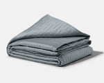 The Classic Grey 20 lb Gravity Cooling Weighted Blanket is neatly folded.