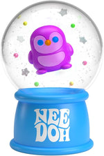 A purple penguin floats in a Snow Globe surrounded by colorful beads and snowflakes.