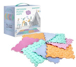 The product box for Ortodon Puzzle Mats in front of the 8 different pastel mats arranged in a pinwheel formation.