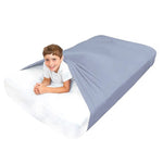 A child lies on their stomach underneath the Grey Queen Sized Compression Bed Sheet.