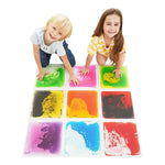 Two children kneel at the rear of a 3x3 tile formation. They are pressing down on the tiles and smiling.