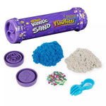 The Flowfetti tube, two separate colors of kinetic sand, two stampers, glitter, and a small scoop tool.