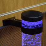 The top of a bubble tube with a Bracket attached to it. The Bracket is nailed to the wall.