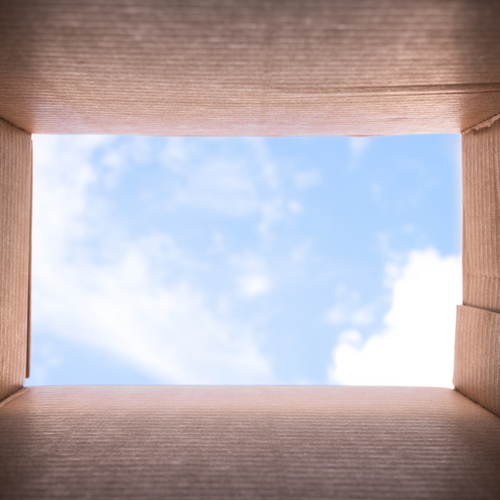 Looking through a box at a blue sky with wispy clouds