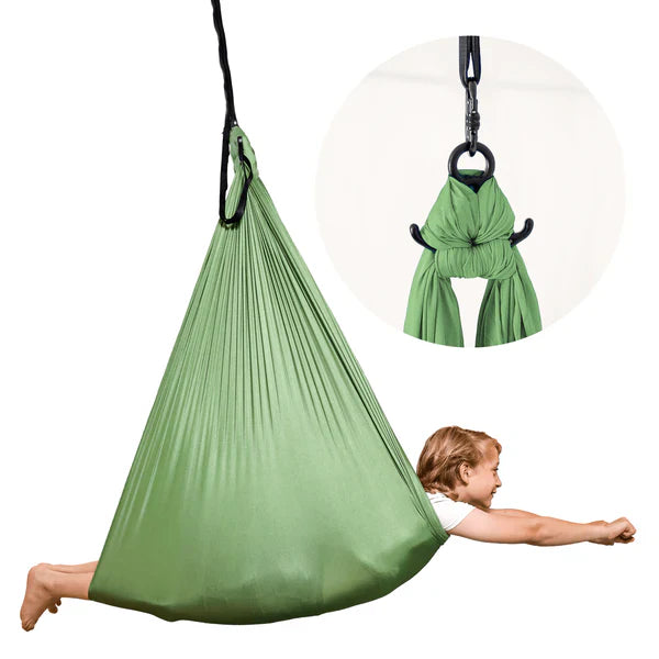 child in a pod swing covering their face