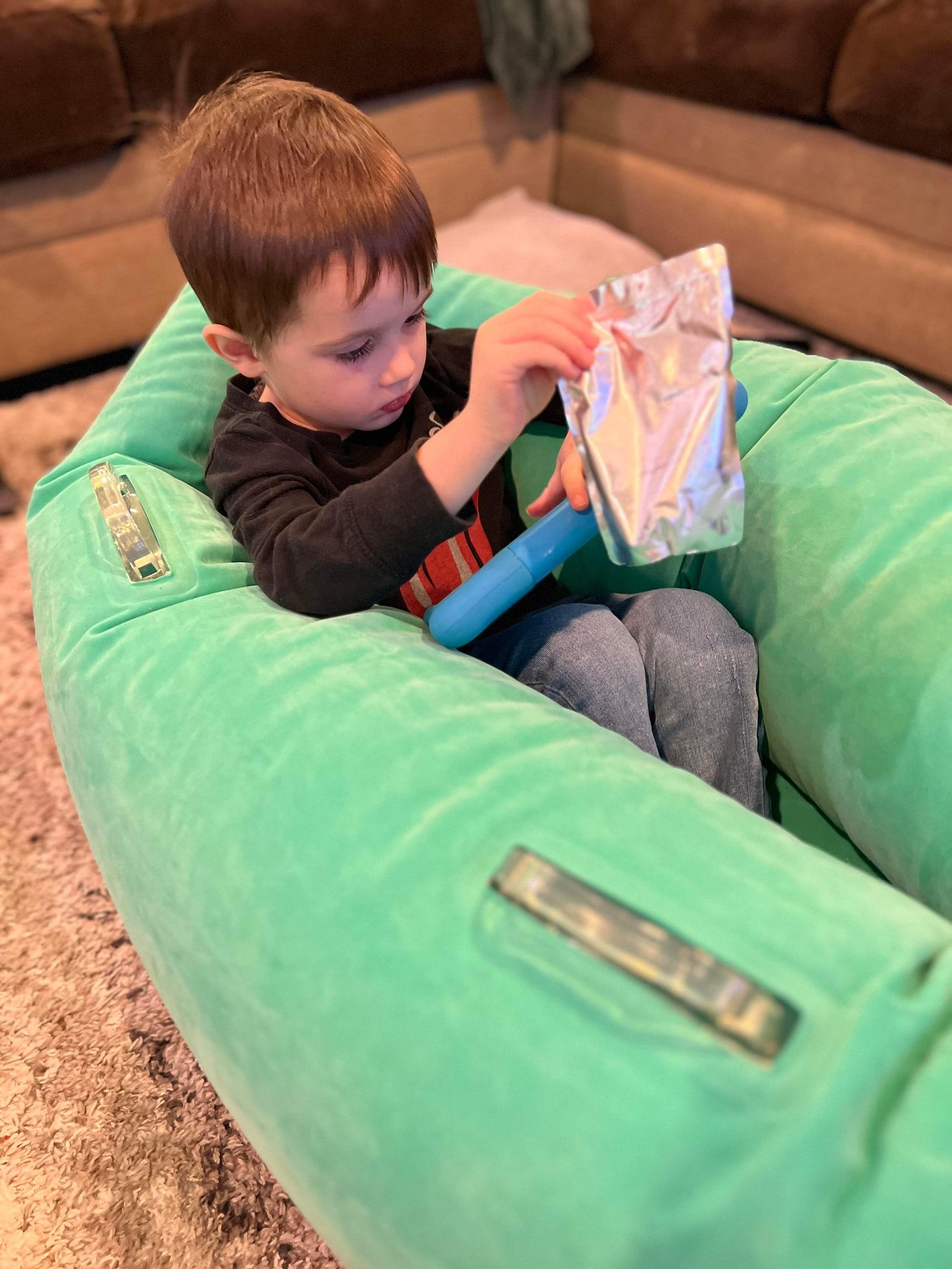 Boy sitting in compression pod reading