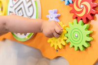 A close up look at the colorful cogs on  the Bear Activity Wall Panel.