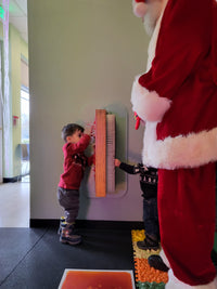 Santa paying with toddlers in a sensory room