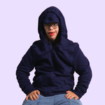 A man sits with his arms on his hips while wearing the Navy QuietSense Zippered Sound Reducing Sensory Hoodie. 