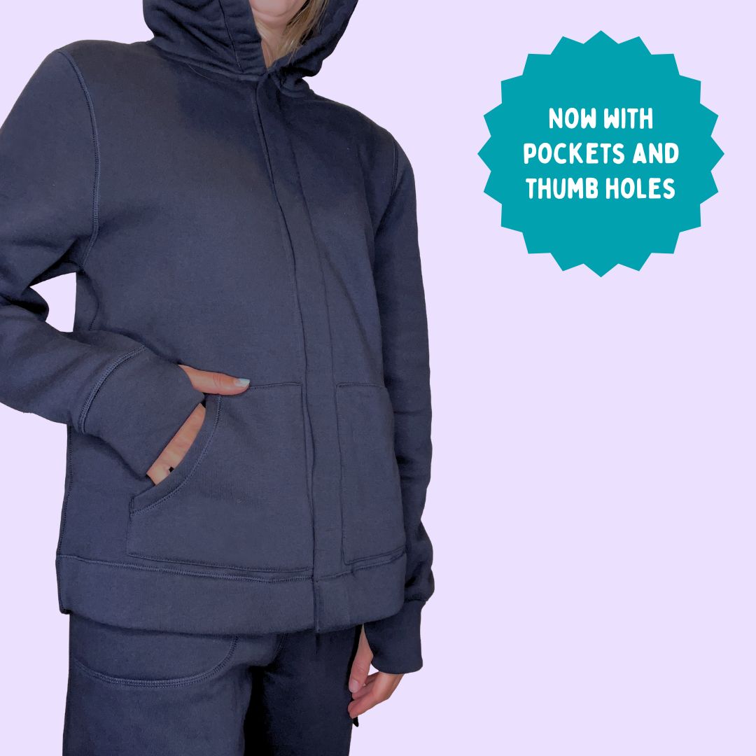 An adult puts their hand into the pocket of  the Navy Sensory Hoodie for Adults.