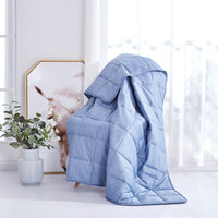 The Dream Theory Polar Air Cooling Weighted Blanket 15 draped over a chair.