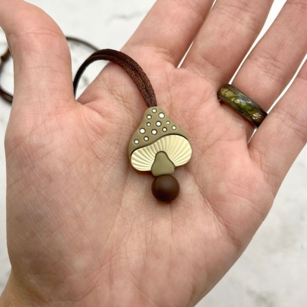 The grey Spotted Mushroom Chewy Fidget Necklace.