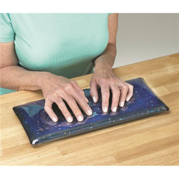 A torso and arms that are light skin tone are sitting at a wooden counter-top. The Sensory Stimulation Gel Pad is in front of the chest, and the hands have fingers that are spread apart and resting on the pad.