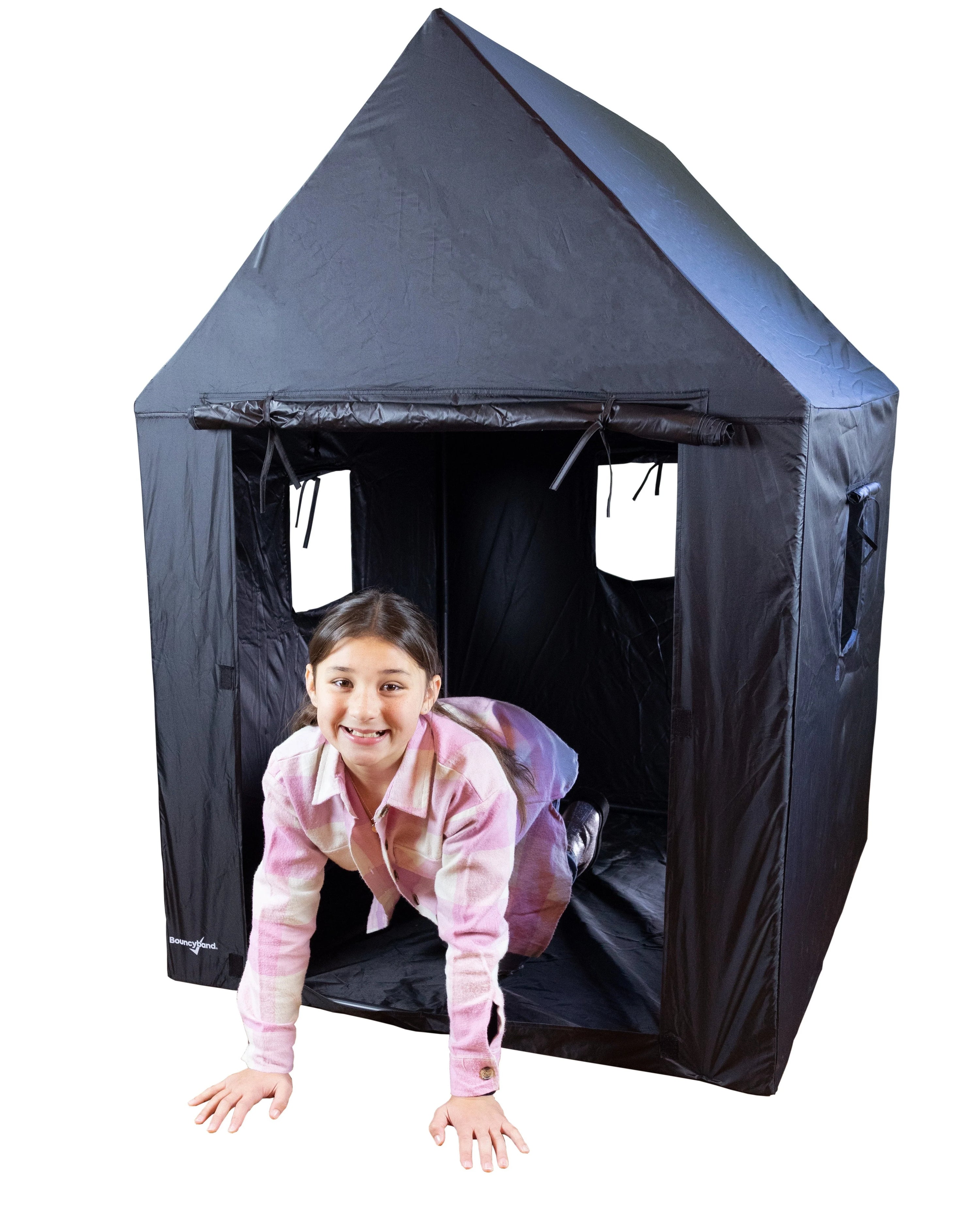 A child with light skin tone and a dark brown ponytail is on their hands and knees, half in and half out of the Indoor Framed Dark Den.