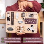 Someone is holding up the Fidget Busy Board for Adults by the handle.