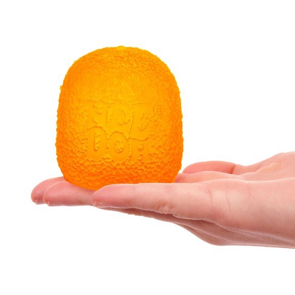An orange Gumdrop Nee Doh sits on an open hand.