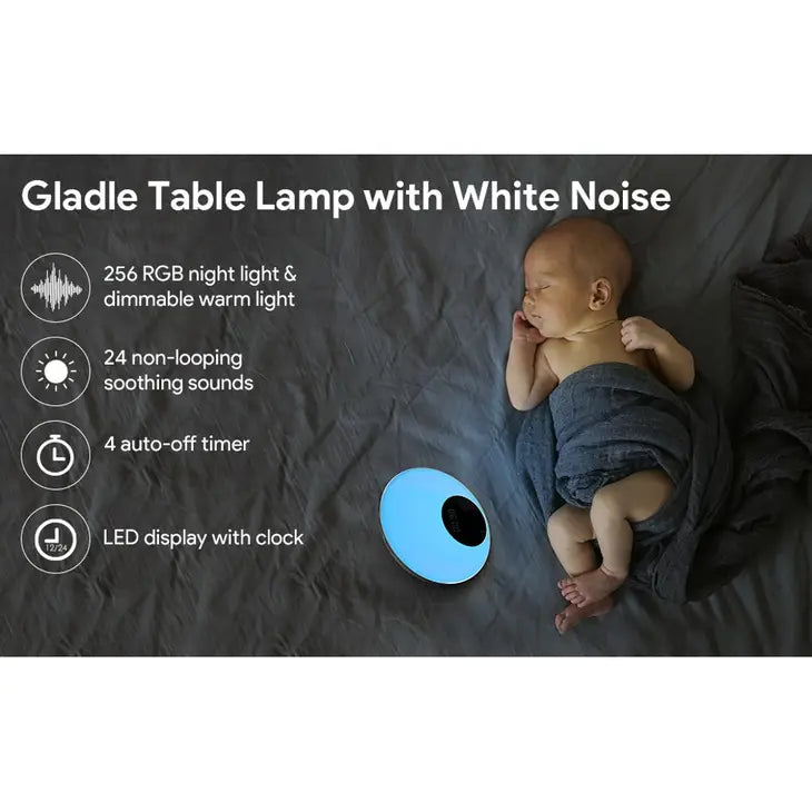 A picture with an infant with light skin tone wrapped in a blanket that appears to be sleeping. The Table Lamp with White Noise is turned to a green setting and warmly illuminating baby.