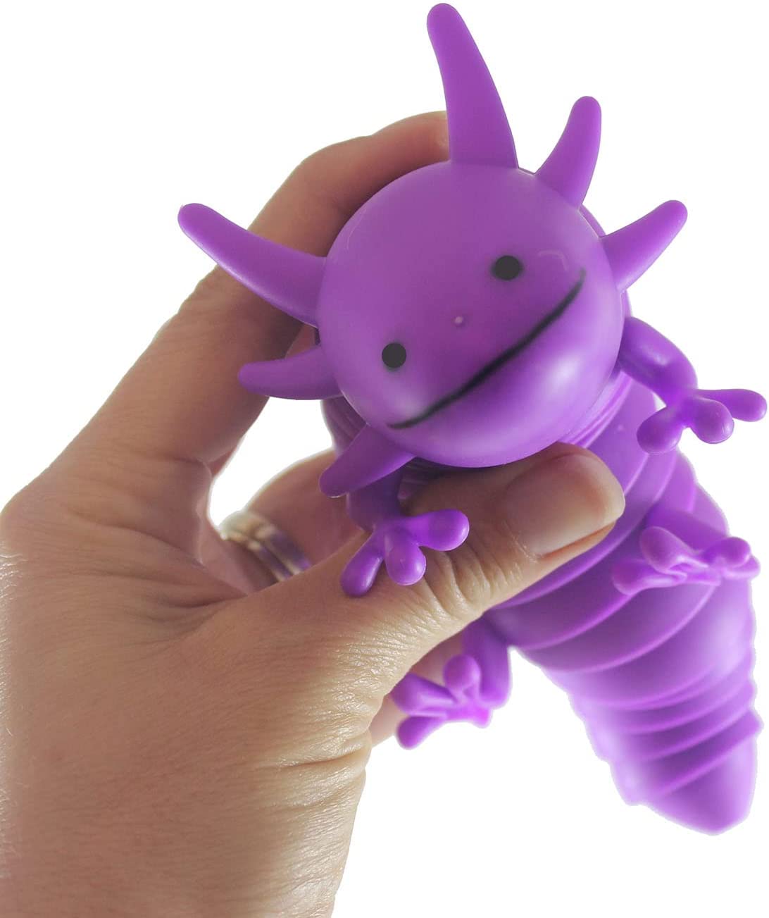 A hand with light skin tone holds up a purple Wiggle Sensory Axolotl.