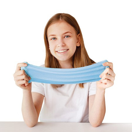 A child with light skin tone and long light brown hair is smiling and holding a blue string of Floof Stretch between either hand.