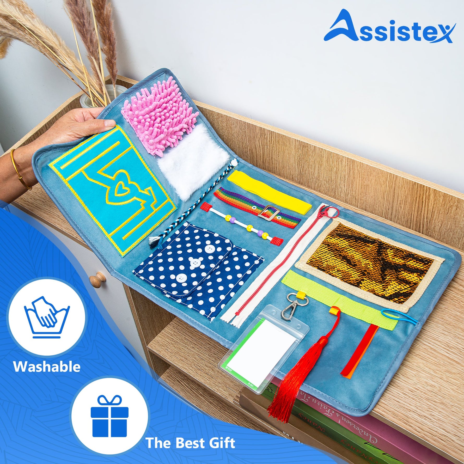 A hand folds over the Assistex Fidget Blanket.