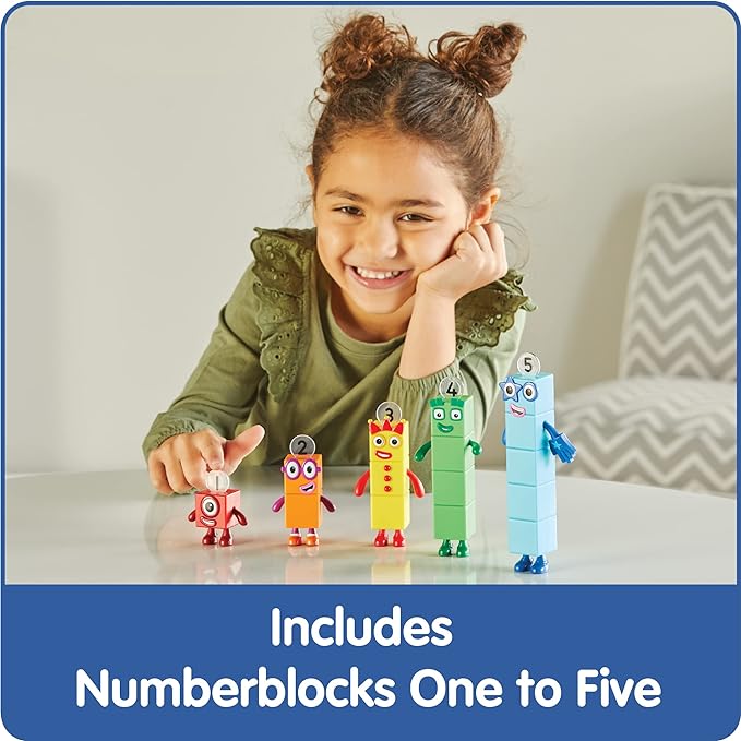 A child wtih medium-light skin tone and two curly brown space buns smiles while sitting behind the Numberblocks Figures One to Five.