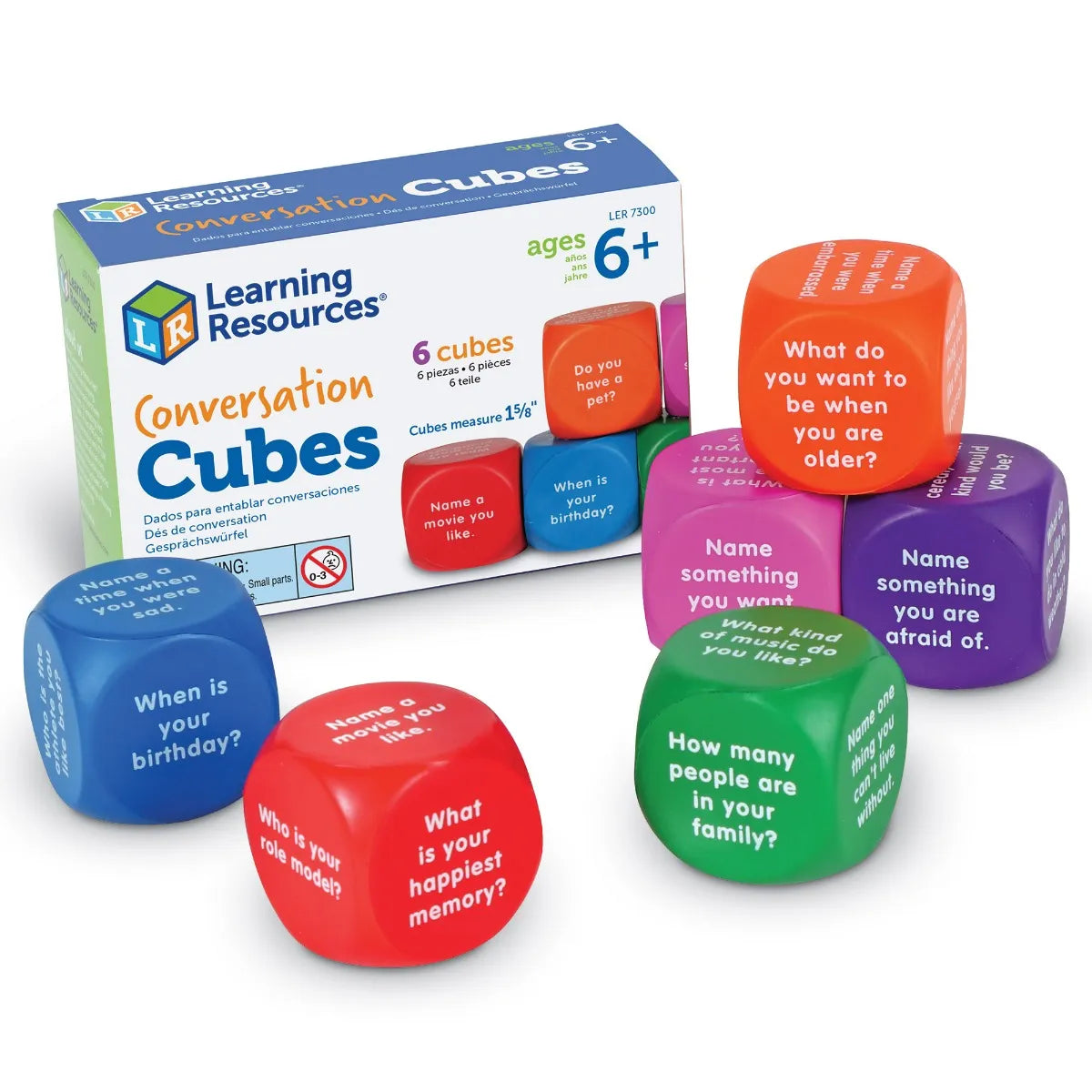 The product package for Conversation Cubes, with several of the cubes placed in front of the box.