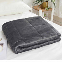The grey Antimicrobial Plush Mink Weighted Blanket 12 lb folded neatly on a made bed.