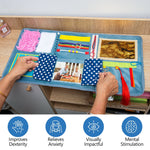 A pair of hands open the fabric window to the photograph in the Assistex Fidget Blanket.