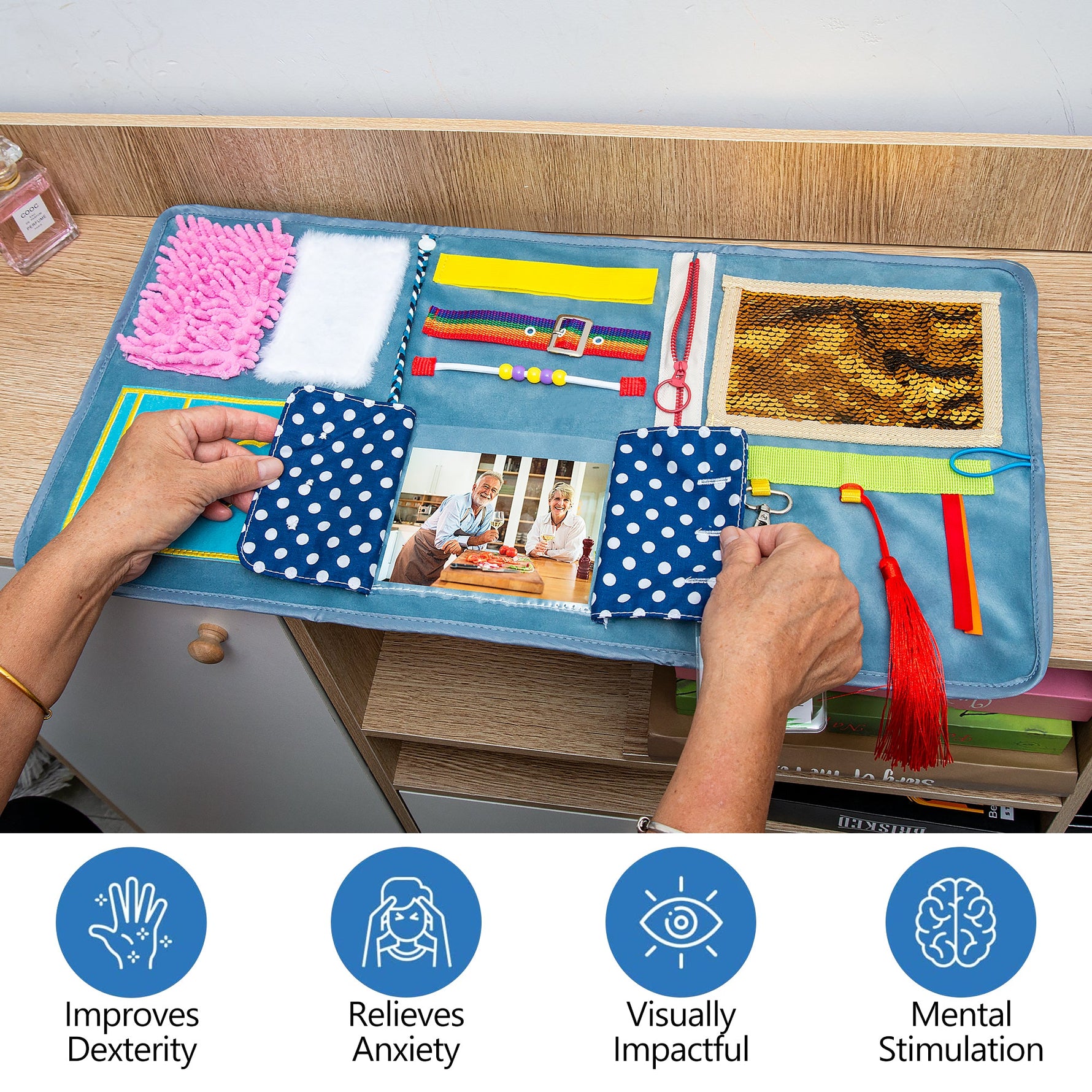 A pair of hands open the fabric window to the photograph in the Assistex Fidget Blanket.