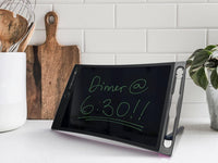 A Boogie Board Jot sits up on its kickstand in a kitchen. It says "Dinner @ 6:30!!!!: