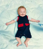 A baby wearing Kozie Medical and G-Tube One-Piece Shorts - The Nathan.