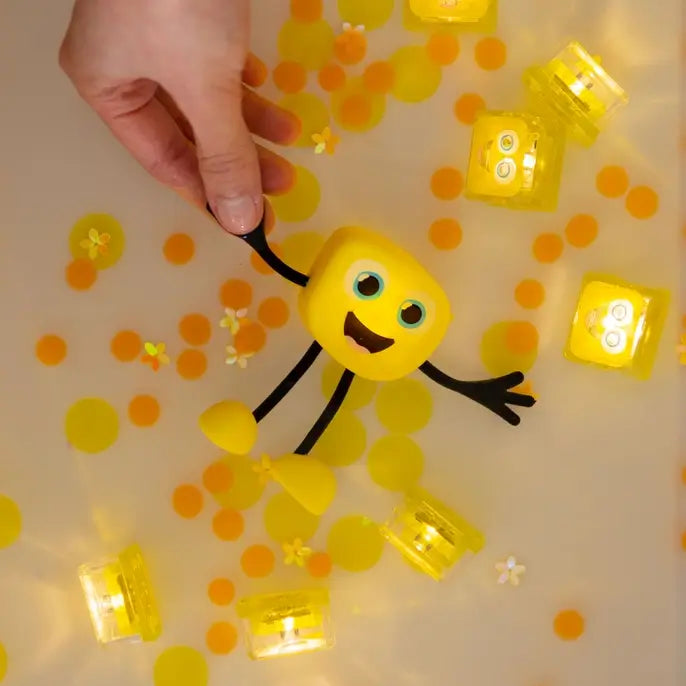 Glo Pals Light-Up Sensory Toy Alex lit up in a tub.