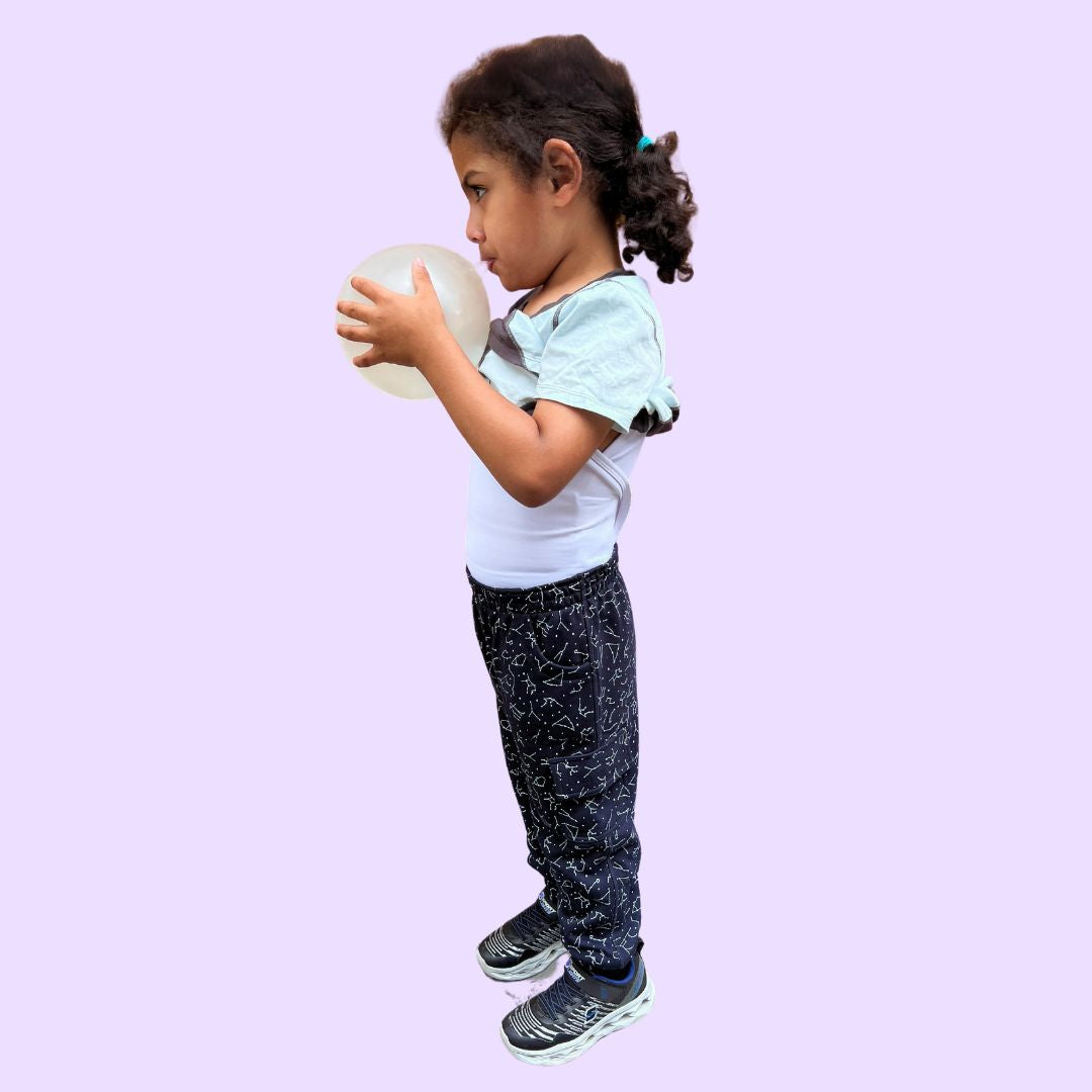 A child wears the Light Blue Compression Lined T-Shirt with the outer layer rolled up for a more revealing look at the compression undershirt.