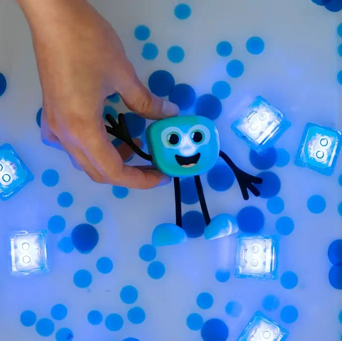 Glo Pals Light-Up Sensory Toy Blair lit up in a tub.