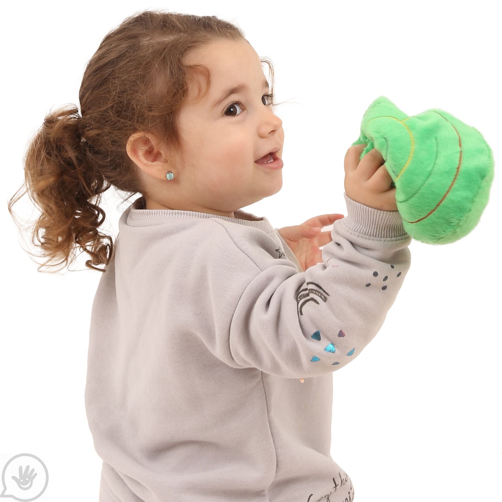 A very small child with light skin tone and a curly brown ponytail holds up the Round Marble Maze.