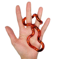 A hand with light skin tone has the Fire Tangle Jr. Crush wrapped around the middle and ring fingers.