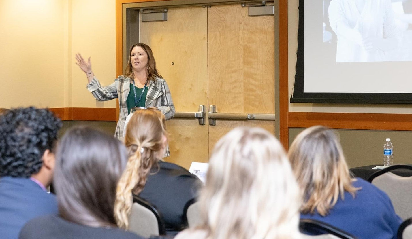 Woman speaking in front of an audience