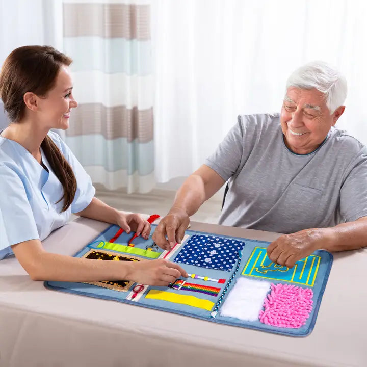 Man using fidget blanket with healthcare worker