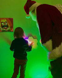 Santa paying a child in a sensory room