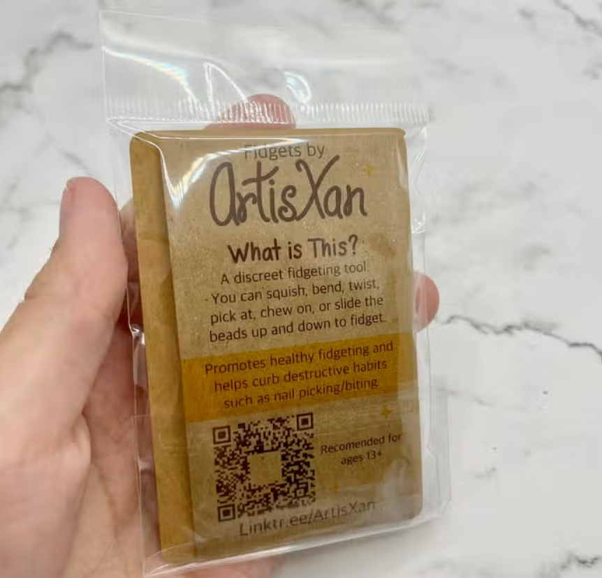 The back of the product package for the Crescent Moon Phases Fidget Necklaces.