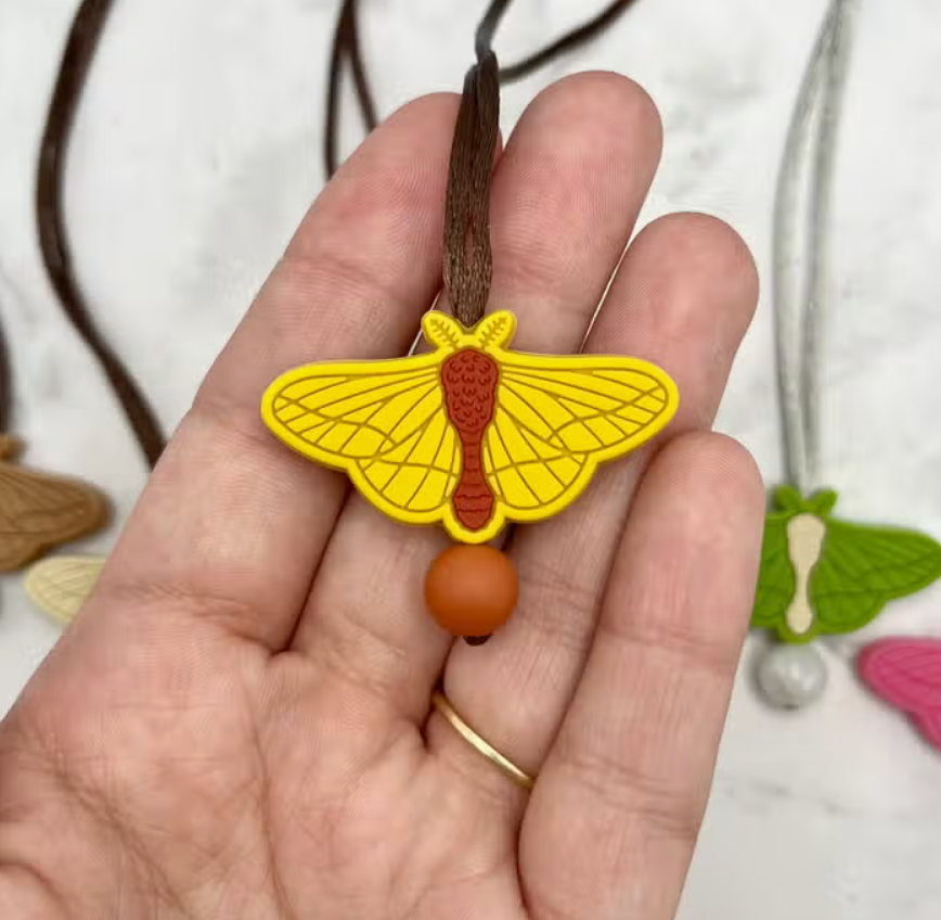 The yellow Moth Fidget Necklace.