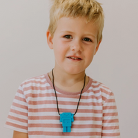 A child with light skin tone and short blonde hair wears the blue Robot Pendant.