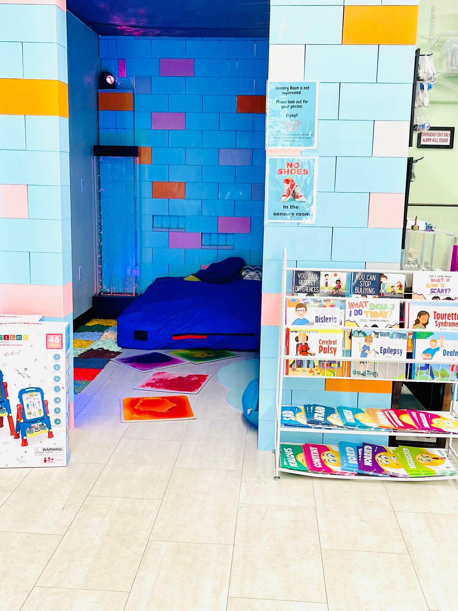 Sensory Room with bubble wall and crash pad. Walls made from giant lego bricks