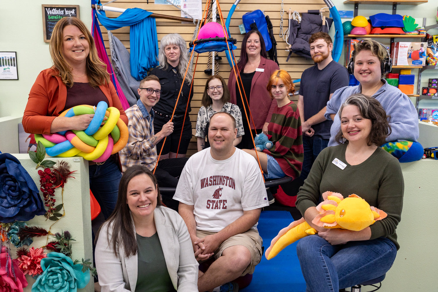 Eleven people gathered smiling