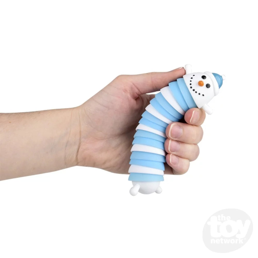 A hand with light skin tone holds up the Sensory Wiggle Snowman Fidget.