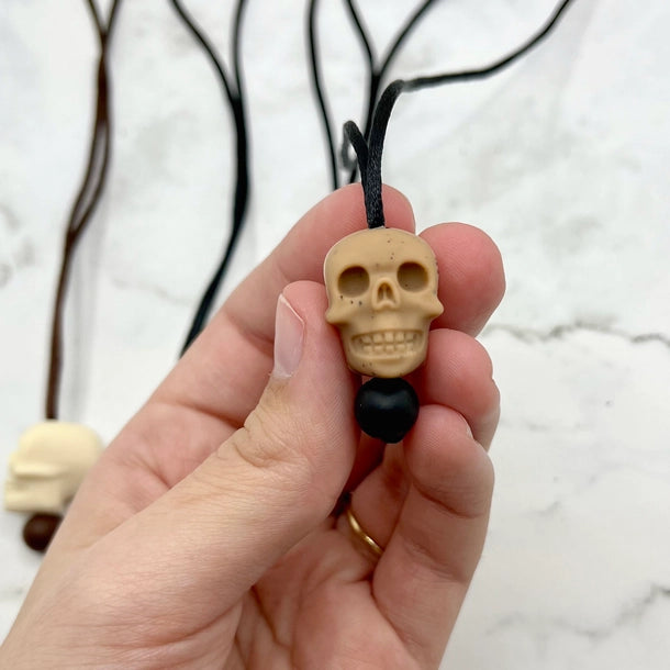 The brown speckled Skull Fidget Necklace.