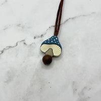 The blue Spotted Mushroom Chewy Fidget Necklace.